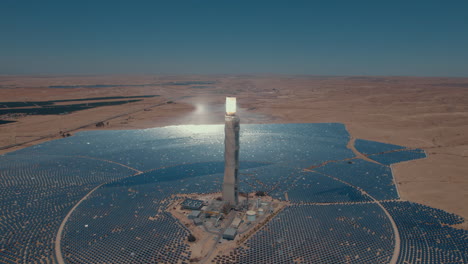 Solar-power-tower-focused-sunlight-for-movable-mirrors-at-the-desert-sun-non-time-in-a-cloudless-day3--slow-tracking-drone-shot