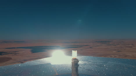 Solar-power-tower-focused-sunlight-for-movable-mirrors-at-the-desert-in-a-cloudless-day--close-up-drone-dolly-in-shot