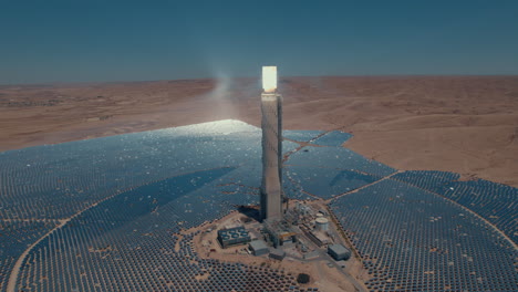 Solar-power-tower-focused-sunlight-for-movable-mirrors-at-the-desert-sun-non-time-in-a-cloudless-day2--slow-tracking-paralax-drone-shot-from