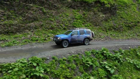 SUV-Car-Driving-On-Muddy-Abano-Pass,-Most-Dangerous-Mountain-Road-In-Tusheti,-Georgia