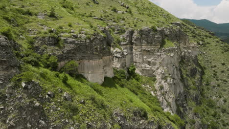 Revolve-On-Craggy-Mountains-Over-The-River-Flowing-Near-Khertvisi-Fortress-In-Georgia