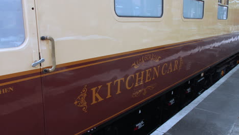 A-steam-train-vintage-kitchen-car-carriage-at-a-railway-station