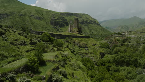 Flying-Over-The-Lush-Green-Trees-In-The-Valley-And-Ancient-Farming-Terraces-To-Khertvisi-Fortress-IN-Georgia