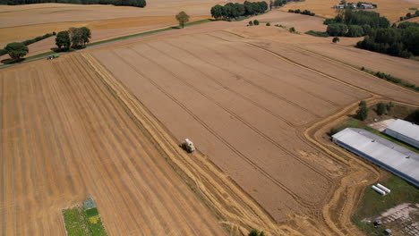 Aerial-View-Of-Agricultural-Combine-Harvesting-Rye-On-The-Field---drone-shot