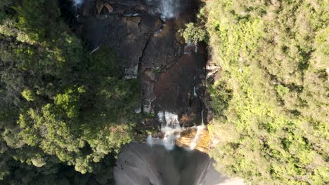 Waterfall-seen-from-above-with-a-drone-following-the-stream-over-the-rocks