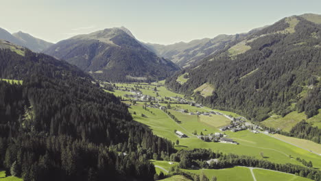 Aerial-over-picturesque-tyrolean-countryside-with-forest-covered-mountains-and-grassy-fields-2