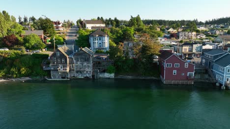 Aerial-shot-of-worn-down-waterfront-buildings-in-Coupeville,-WA-at-sunset
