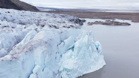 Retreating-ice-glacier-upvalley-in-Iceland,-global-warming-impact,-aerial