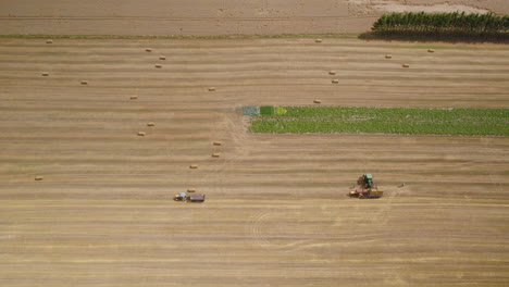 Aerial-Overhead-View-Of-Tractor-Reversing-On-Harvest-Field