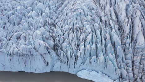 Sharp-jagged-ice-sheets-on-spectacular-glacier-Fjallsárlón,-aerial