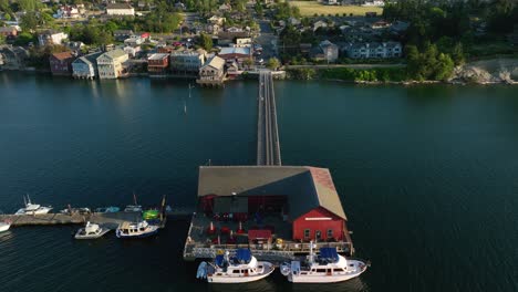 Aerial-shot-flying-over-the-pier-in-Coupeville,-WA-to-reveal-the-main-street-amenities