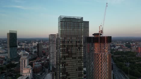 Aerial-drone-flight-around-Deansgate-Towers-showing-skycrapers-and-new-construction-of-skyscrapers-in-Manchester-United-Kingdom