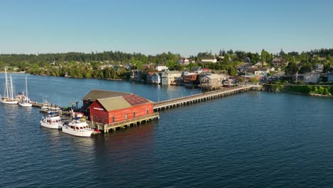Orbiting-drone-shot-of-the-Coupeville-Wharf-extending-from-the-historic-downtown