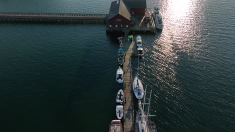 Top-down-aerial-shot-of-boats-tied-up-to-the-dock-in-Coupeville,-WA