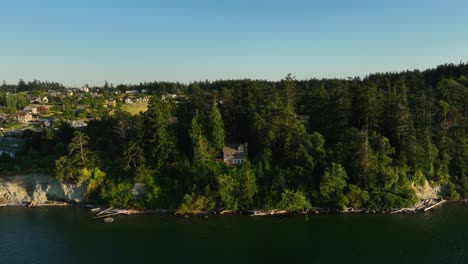 Aerial-view-pushing-towards-a-long-house-on-the-Cpupeville-shoreline