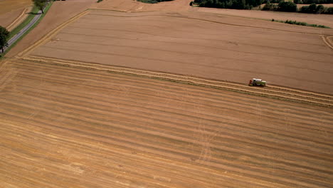 Aerial-View-Of-Lone-Harvester-In-Large-Wheat-Farmland