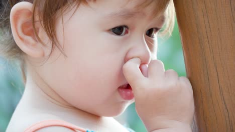 Little-girl-picking-her-nose