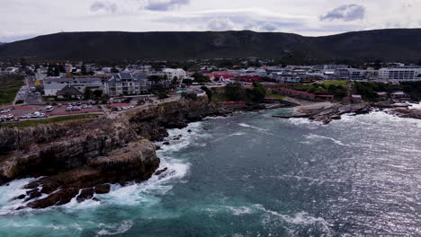 Coastal-drone-flight-reveals-historic-Old-Harbour-and-Gearings-Point,-Hermanus