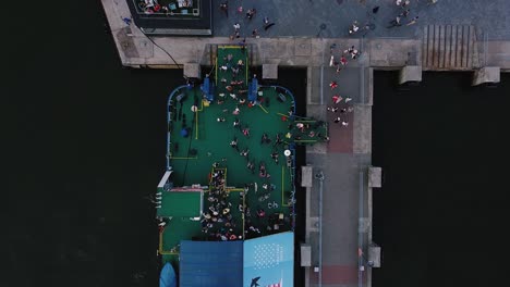 Aerial-drone-shot-of-People-leaving-the-ferry