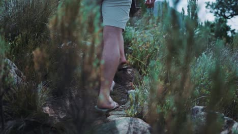 Cinematic-shot-of-couple-going-for-a-hike-and-using-sandals