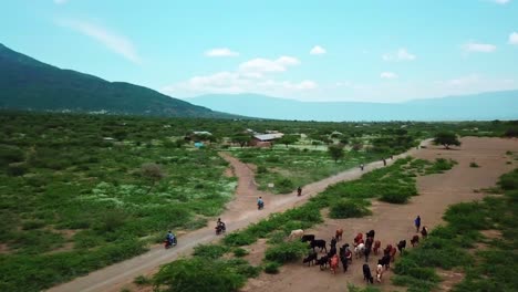 Travelers-During-Motorcycle-Tours-Around-Lake-Natron-In-Tanzania---aerial-drone-shot