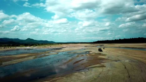 Lake-Magadi-With-Tourists-On-Motorcycles-Enjoying-Scenic-Scenery-In-Kenya---aerial-drone