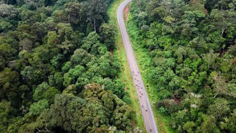 Tourists-Riding-Motorcycles-In-The-Hills-Of-Chogoria-With-Lush-Vegetation-In-Kenya---aerial-drone-shot