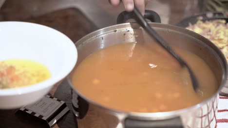 Serving-hot-soup-from-a-pot