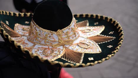 Close-up-of-a-guy-wearing-on-a-traditional-Mexican-sombrero