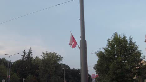 Beautiful-red-and-white-polish-flag-being-waved-by-the-wind-in-the-heart-and-capital-of-Poland,-Warsaw