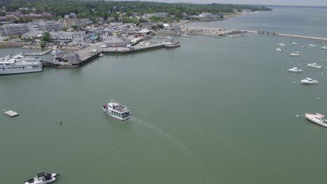 Ferry-arriving-at-the-Plymouth-Harbor-in-Massachusetts,-USA---orbit,-aerial-view