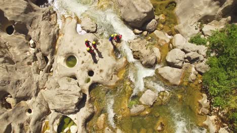 People-walking-over-river-on-rocks