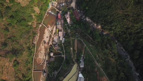 Overhead-view-of-Cat-Cat-Village-and-a-brown-river-in-Sapa-Vietnam