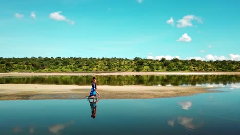 Tourist-Woman-With-Masai-Walking-Along-Lake-Magadi-In-Kenya---drone-shot