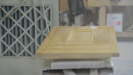Wooden-Cupboard-Door-is-Sprayed-by-Hand-in-Industrial-Factory
