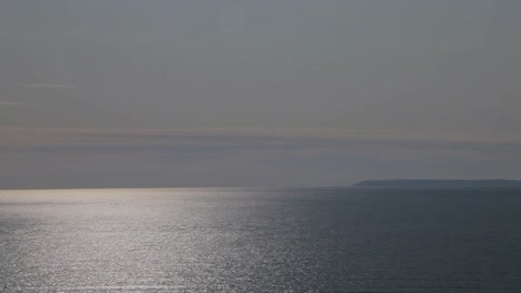 Lundy-Island-Panning-Shot-from-Woolacombe-Bay-with-Sun-Reflecting-on-the-Sea