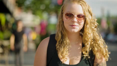 Girl-wearing-sunglasses-and-long-hair-walks-across-crosswalk
