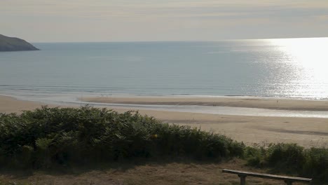 Woolacombe-Beach-Panning-Down-Shot-to-Reveal-Lone-Bench-with-Lundy-Island-View