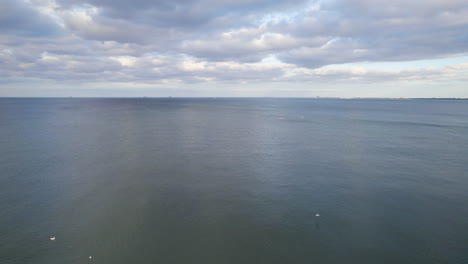-Vast-And-Sweeping-Horizon-In-The-Baltic-Sea-Near-Gdynia,-Poland-With-Sight-Of-Paddleboarders