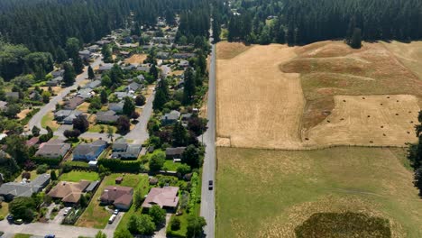 Aerial-shot-showing-the-divide-between-a-community's-neighborhood-and-farmland