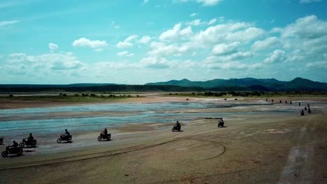 People-Around-Lake-Magadi-In-Kenya-During-Motorcycle-Tour---aerial-drone-shot
