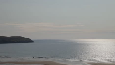 Beautiful-Woolacombe-Bay-Beach-with-Lundy-Island-Background-and-Bright-Sun-Reflecting-on-the-Sea