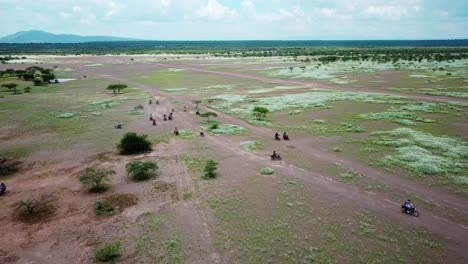 African-Landscape-With-Travelers-Riding-Motorcycles-At-Daytime---aerial-shot