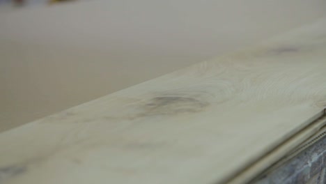 Wood-Board-is-Sanded-Down-by-Hand-in-Workshop-Factory