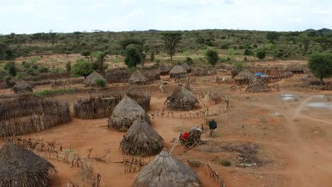 Fly-Over-Fenced-And-Thatched-Roof-Houses-In-Hamar-Tribe-Village-In-Omo-Valley,-Southern-Ethiopia