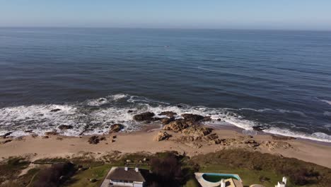 Aerial-flight-over-town-with-luxury-houses-in-front-of-Atlantic-Ocean-in-Uruguay