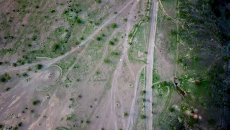 Overhead-View-Of-Motorcycles-Traveling-In-Winding-Roads-Within-Lake-Magadi-Nature-Reserve-In-Kenya,-East-Africa