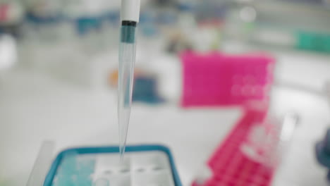 Scientist's-hand-holding-pipette-using-DNA-analysis-for-patient