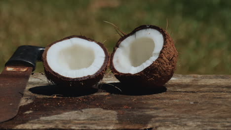 A-coconut-split-in-half-with-a-machete-ready-to-eat-the-fresh,-moist-flesh---sliding-view
