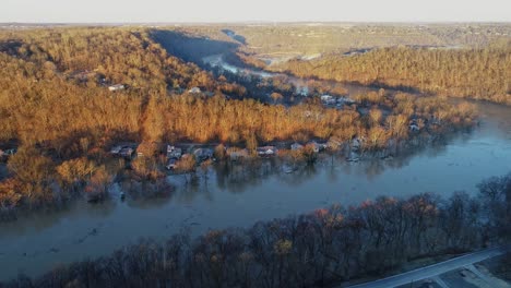 Aerial-of-Kentucky-forest-hills-at-golden-hour-sunset-with-river-flooded-homes